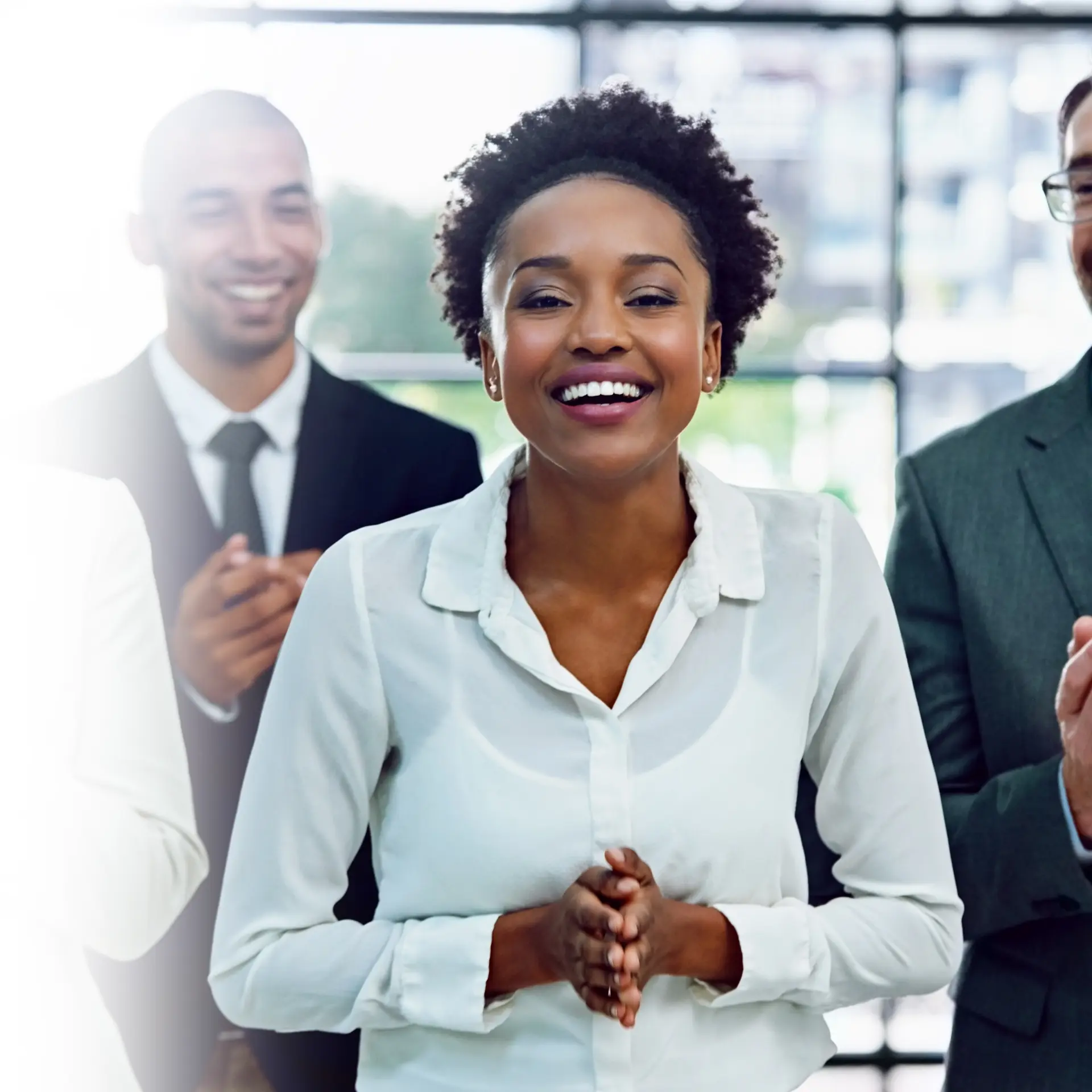 A group of smiling colleagues in a bright office